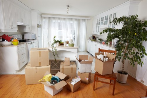 Removal team handling boxes and furniture for a local move in St Jamess