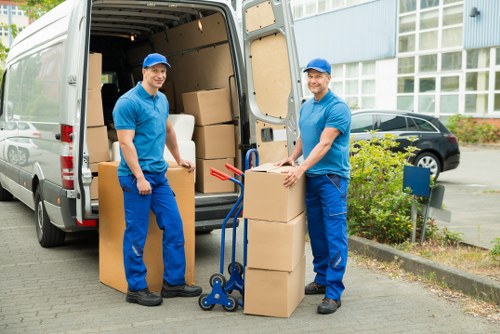 Office relocation process showing labelled furniture and boxes